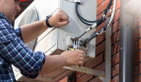 Technician Repairing Outdoor Air Conditioner — Northern Air in Ocean Shores, NSW